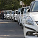Drivers of Uber and Ola walk next to their parked vehicle's during a protest in New Delhi